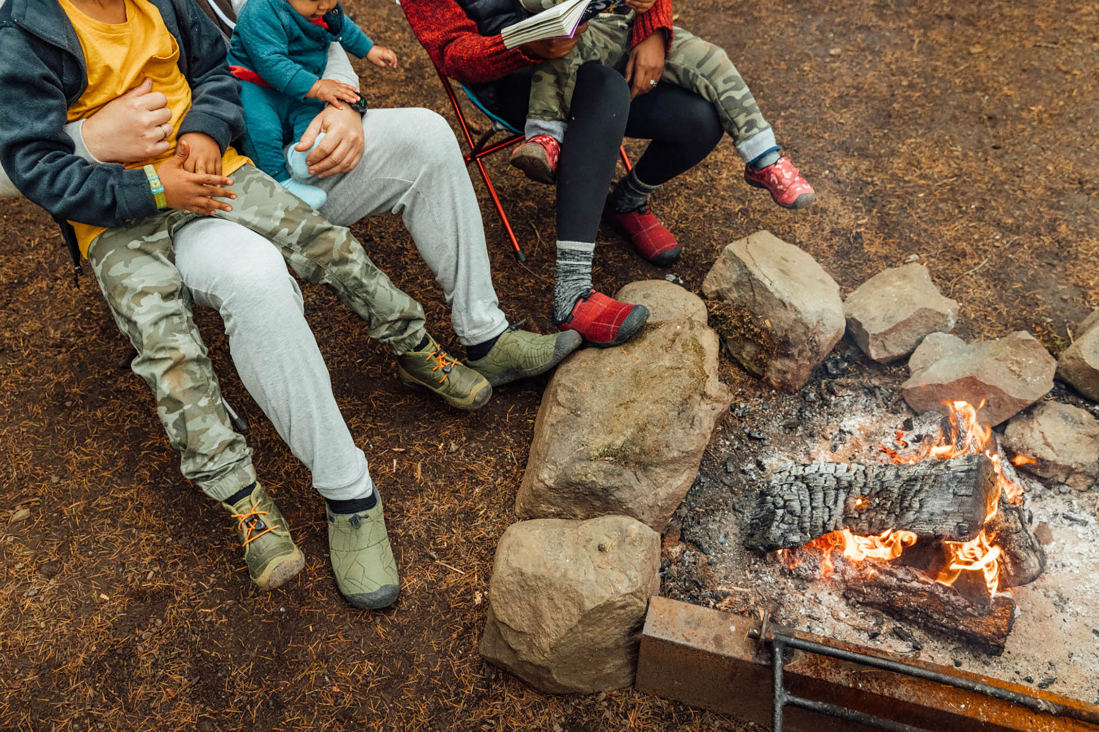 A family sitting around a campfire