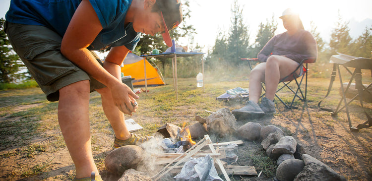 Kids learning how to build a campfire