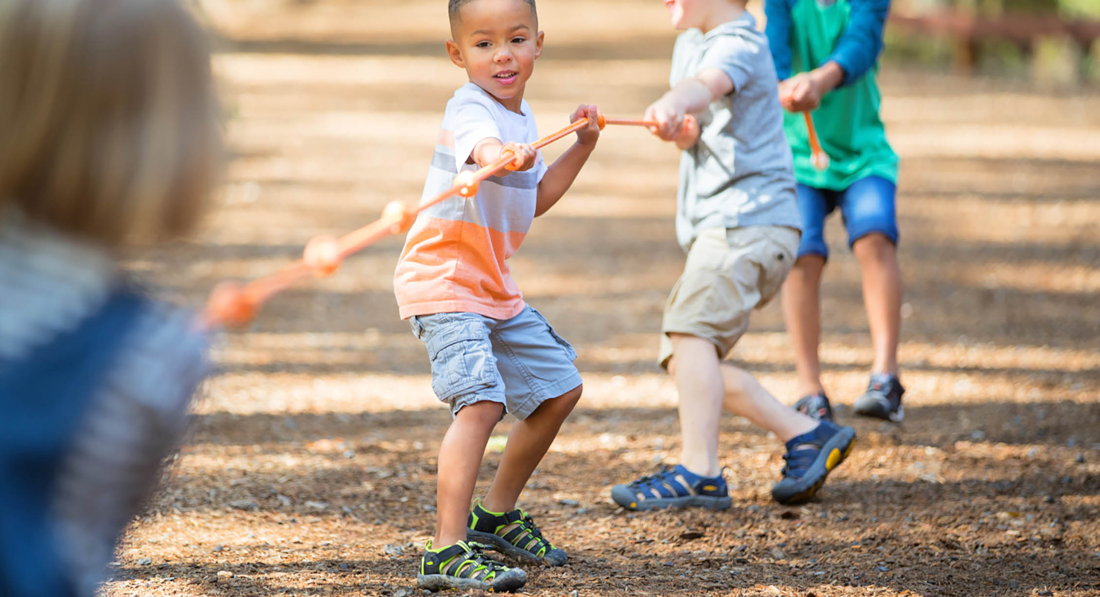 Kids playing tug of war at summer camp