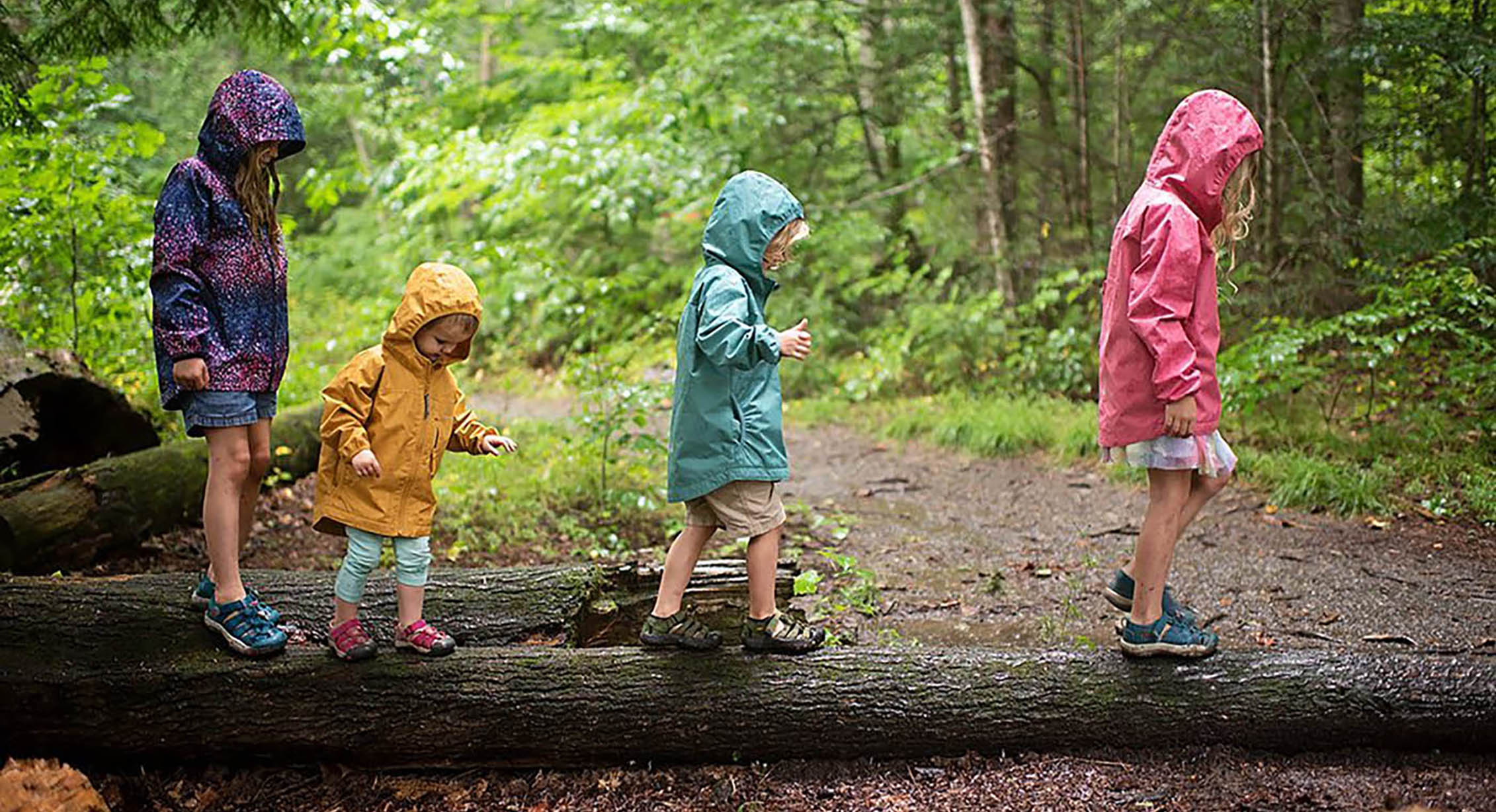 a family playing on a trail on a rainy day