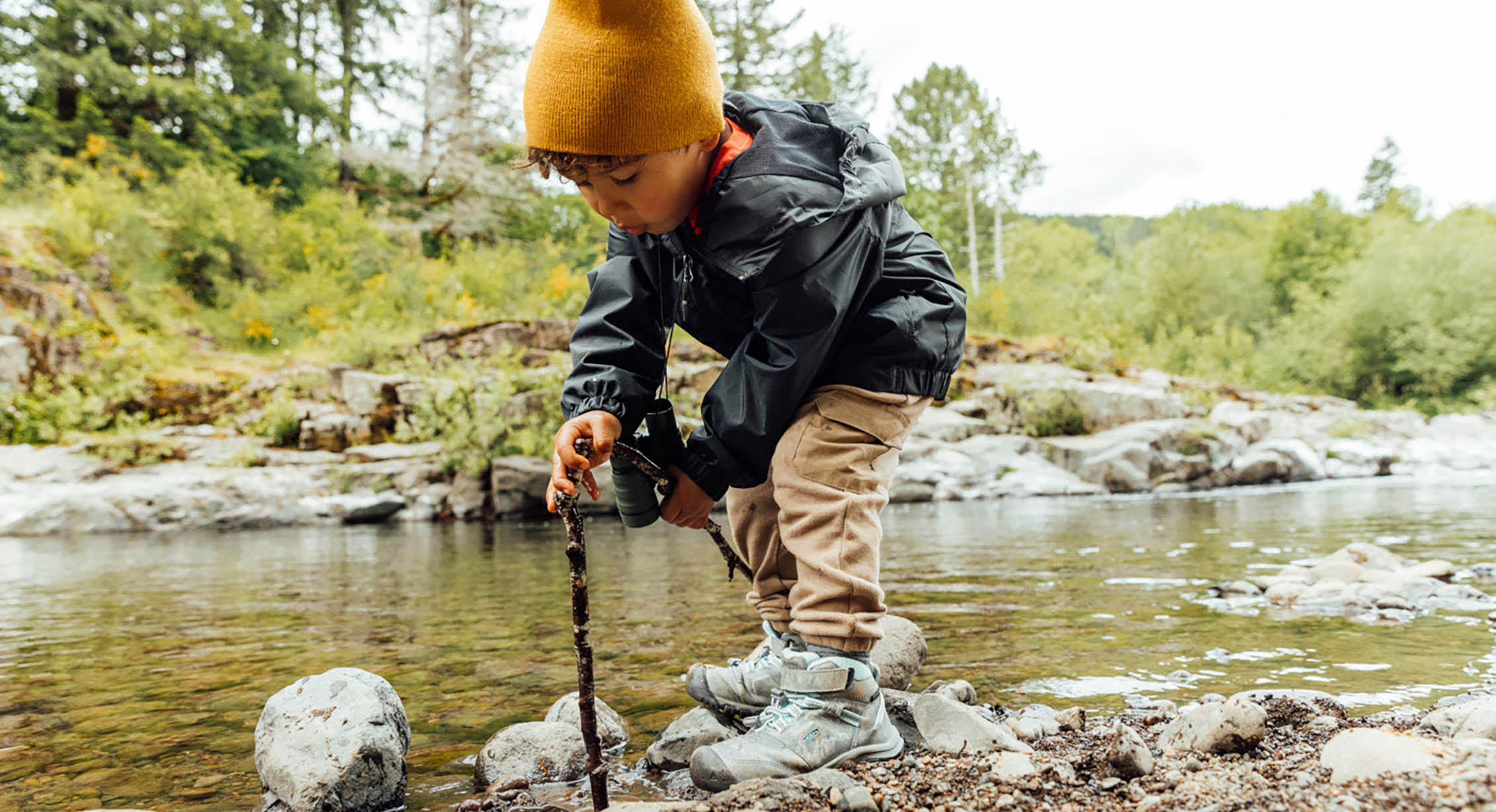 a child playing by a stream