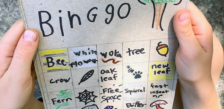 A child playing with a handmade Nature Bingo board