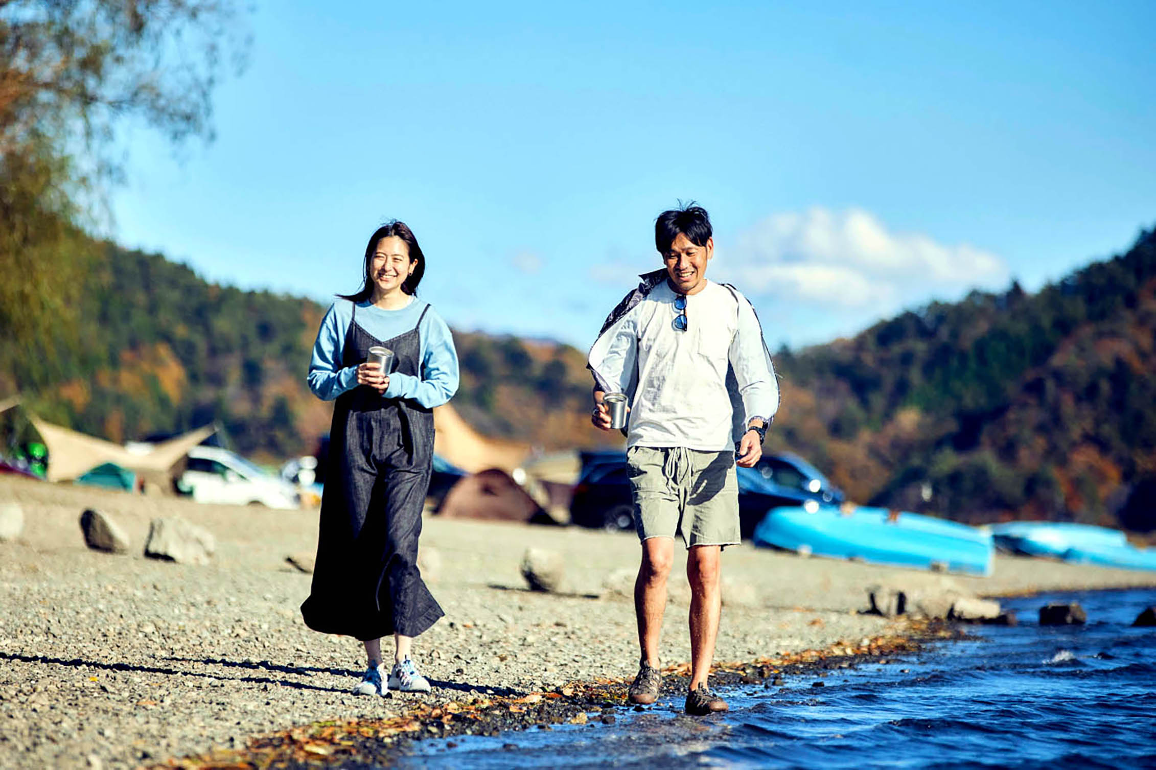 A couple walking along water