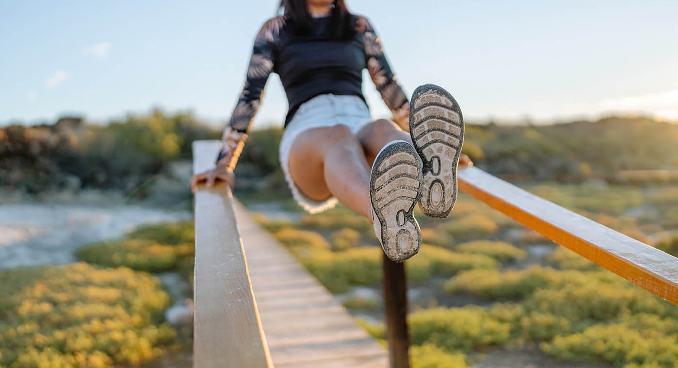 A woman kicking up her KEEN water sandals