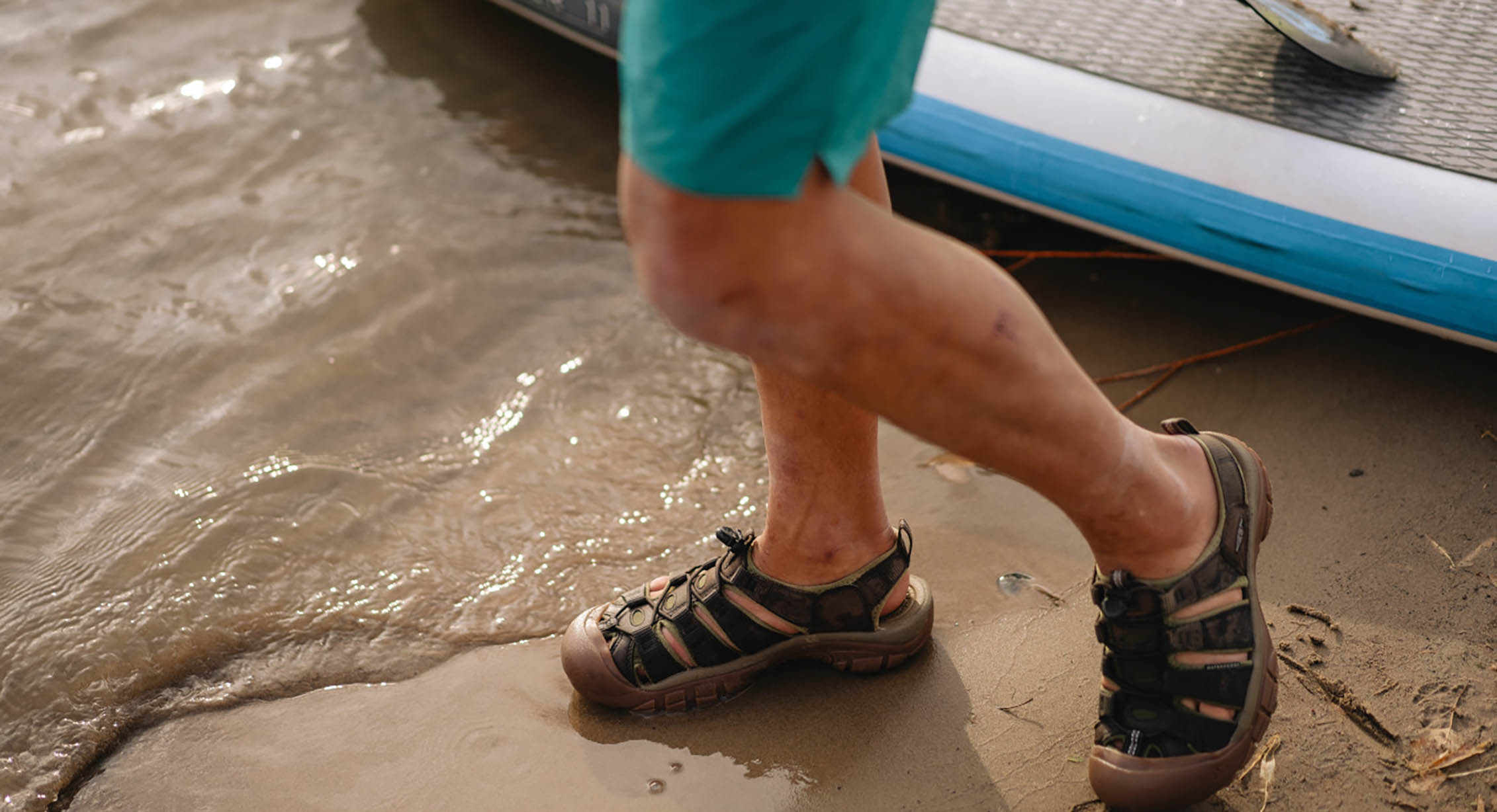 A person wearing KEEN closed-toe sandals after paddleboarding