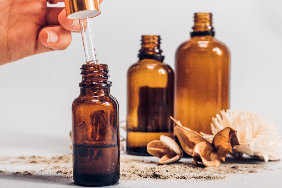 A selection of different essential oils in small glass bottles